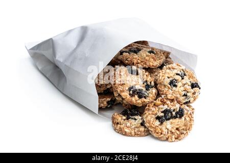 Healthy  protein granola crackers with raisins and nuts in paper bag isolated on white Stock Photo
