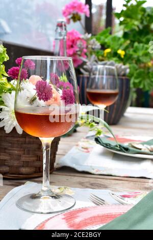 Secluded outdoor patio cafe setting in beautifully landscaped garden on lovely summer evening to enjoy al fresco meal Stock Photo