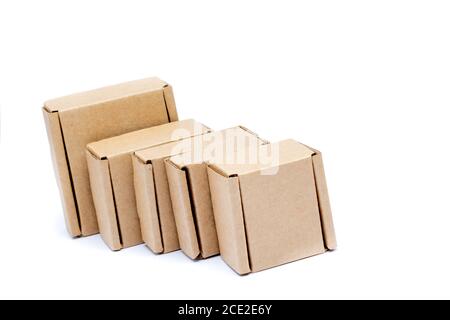 Cardboard boxes of various sizes are arranged in a row diagonally. Isolated on a white background. Stock Photo