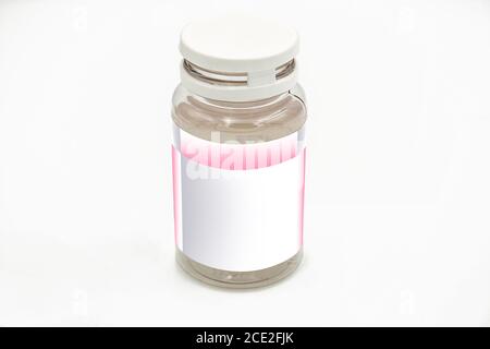 An empty pill bottle with white and pink label mockup, on a white background, ideal for pharmaceutical and research use Stock Photo