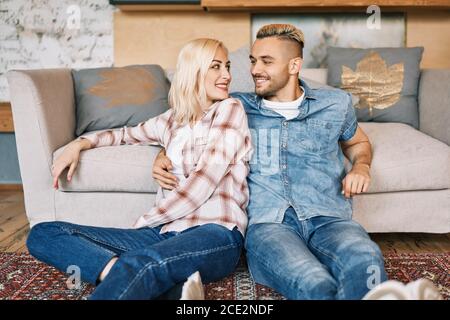 Young happy couple portrait relax and hugging at home Stock Photo