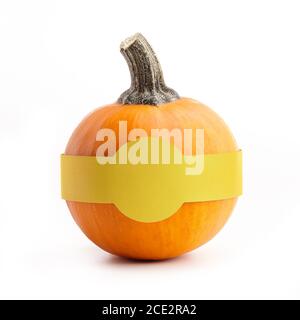 Round little pumpkin with paper sticker for text isolated on white background Stock Photo