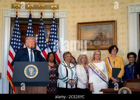 U.S. President Donald Trump delivers remarks during an event marking the 100th Anniversary of the Ratification of the 19th Amendment in the Blue Room of the White House August 18, 2020 in Washington, DC. Stock Photo