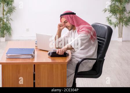 Male arab employee working in the office Stock Photo