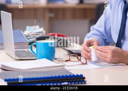 Sick male employee suffering at the workplace Stock Photo