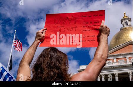 August 30, 2020, Boston, Massachusetts, USA: Protester holds a 'Don't trust Bil Gates' sign during anti flu shot mandate rally in Boston. Hundreds of the anti flu shot protesters rally against Massachusetts flu vaccine mandate outside of the Statehouse on August 30, 2020. Massachusetts public health officials announced on August 19 that influenza immunization were now required for all students over 6 months old at pre-school, K-12, and colleges unless either a medical or religious exemption is provided. Students will be expected to have received a flu vaccine by December 31, 2020, for the 202 Stock Photo