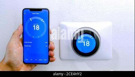 Calgary, Alberta, Canada. Aug. 29, 2020. A person cooling down with air conditioner with a iPhone 11 Pro Max using the nest app on celsius metrics usi Stock Photo
