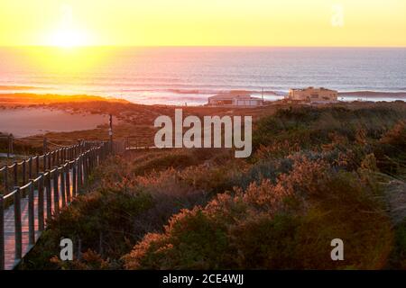 Praia do Guincho Beach and Hotel Fortaleza on a summer day in Sintra, Portugal Stock Photo