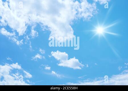 blue sky with sun and clouds background Stock Photo