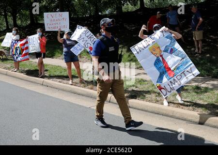 Protesters react outside Trump National Golf Club as U.S. President Donald Trump's motorcade passes by in Sterling, Virginia on August 30, 2020. Credit: Yuri Gripas/Pool via CNP/MediaPunch