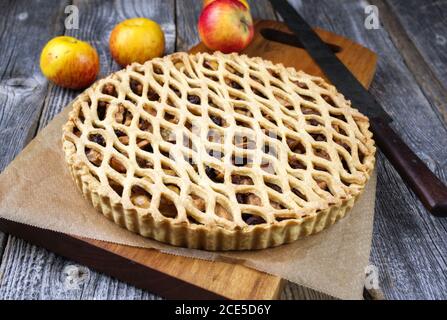 Traditional apple jalousie cake offered as closeup on a modern design wooden board Stock Photo