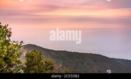 Sunset views in Santa Cruz mountains; Smoke from the nearby burning wildfires, covering the entire sky and San Jose, barely visible in the valley; Sou Stock Photo