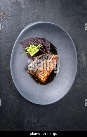 Minimalistic design Japanese salmon fish filet with vegetable and nori glazed in teriyaki sauce as top view on a modern design p Stock Photo