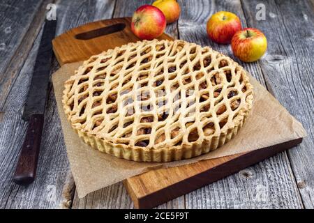 Traditional apple jalousie cake offered as closeup on a modern design wooden board Stock Photo