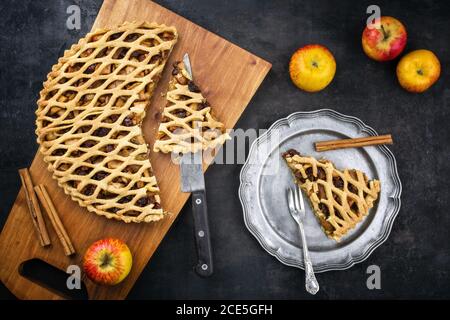 Traditional apple jalousie cake offered as top view on a modern design wooden board and pewter plate Stock Photo