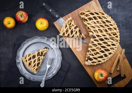 Traditional apple jalousie cake offered as top view on a modern design wooden board and pewter plate Stock Photo