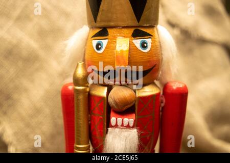 Nutcracker wooden figure of a soldier for cracking nuts. Traditional symbol of Christmas and New Year. Close up Stock Photo