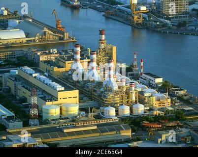 A large factory and industrial complex situated on the waterfront by the harbor Stock Photo