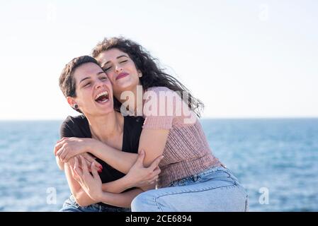 Happy female friends by the beach Stock Photo
