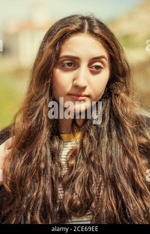 Beautiful teenage girl looking away outdoors Stock Photo