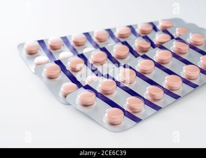 Pink pills placed on a white background.Medical image Stock Photo