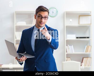 The young handsome businessman employee working in office at desk Stock Photo