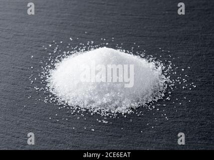 Sugar placed on a black stone plate Stock Photo