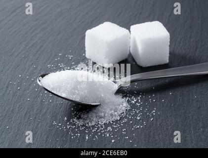 Sugar placed on a black stone plate Stock Photo