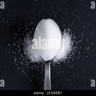 Sugar placed on a black stone plate Stock Photo