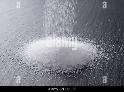 Sugar placed on a black stone plate Stock Photo