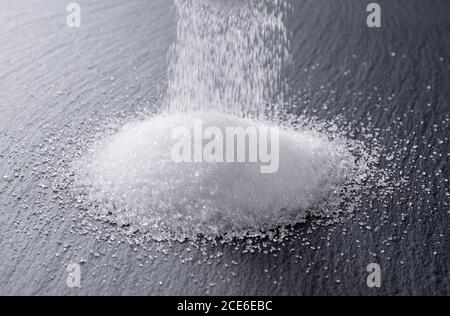Sugar placed on a black stone plate Stock Photo