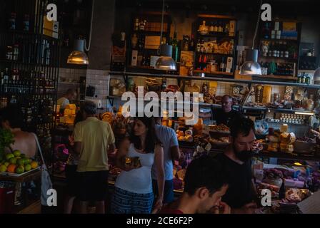 Tourists buying specialties at the famous store Burgio. Ortigia urban area. Syracuse Siracusa, Sicily Italy, summer season Stock Photo