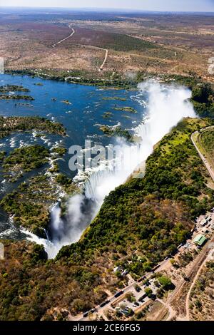 Victoria Falls and Zambezi River, Mosi-oa-Tunya, one of the world's largest waterfalls, Aerial view by helicopter, Zambia, Zimbabwe, border, Africa Stock Photo