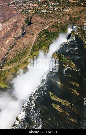 Victoria Falls and Zambezi River, Mosi-oa-Tunya, one of the world's largest waterfalls, Aerial view by helicopter, Zambia, Zimbabwe, border, Africa Stock Photo