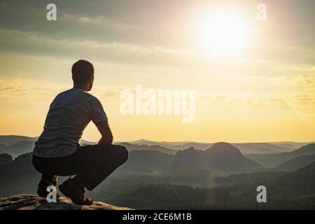 With reconciliation confident man sitting on edge Stock Photo