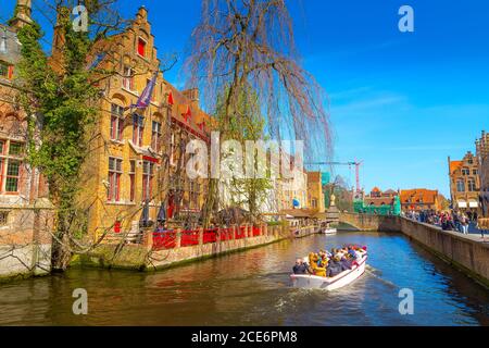 Canal, boat, tourists in Bruges, Belgium Stock Photo