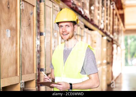 Portrait white caucasian worker with tablet in distribution warehouse Stock Photo