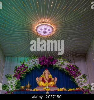 Lord Ganesha decorated with orchid flowers Stock Photo