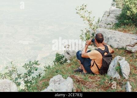 Men taking photos with mobile phone in mountains in a sunny  day Stock Photo