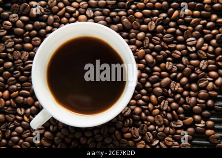 Cup of coffee and grains of coffee on table Stock Photo