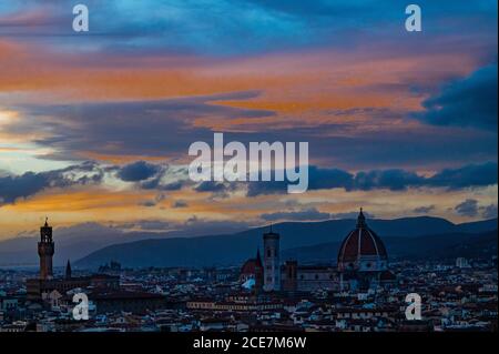 Florence, Italy. 30th Aug, 2020. People crowd on to the terrace and steps of the Piazzale Michelangelo for a panoramic view of the city as the sun sets, some wear masks, some don't - Visitors return to see the varied sights of the historic city of Florence following the easing of Coronavirus (covid 19) travel restrictions. Credit: Guy Bell/Alamy Live News Stock Photo