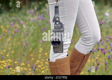 Crop photographer walking in park with vintage video camera Stock Photo