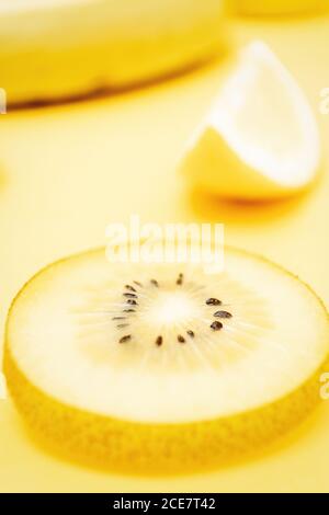 Top view of various fresh fruits and vegetables arranged on yellow background Stock Photo