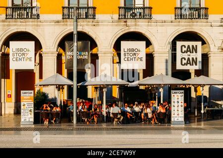 Customers relaxing at a pavement cafe in the Praca do Comercio, Baixa, Lisbon, Portugal Stock Photo