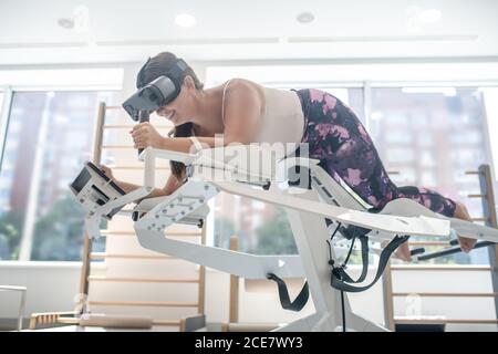 Woman playing a VR game using a VR simulator Stock Photo