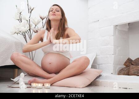 Pregnant woman meditating Stock Photo