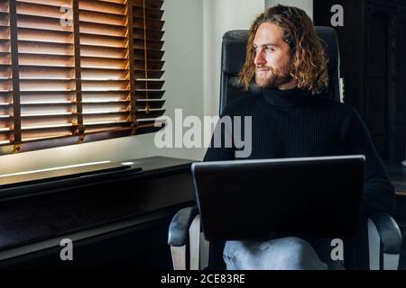 Handsome man working at desktop computer at home Stock Photo