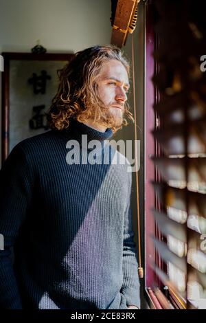 Mature man looking out window Stock Photo