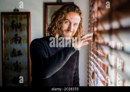 Mature man looking out window Stock Photo