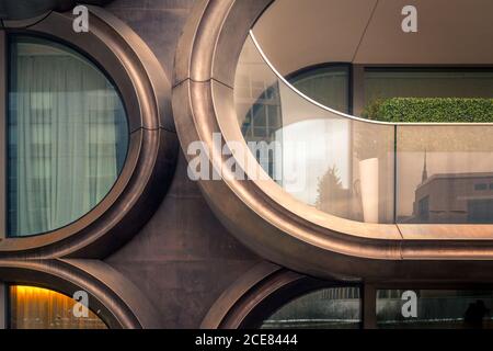 Exterior design of contemporary building with glass walls and geometric shapes of balconies on street of New York City Stock Photo